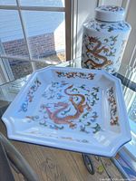 Ginger jar and matching octagonal plate showing dragon motif and condition
