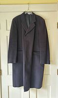 Front view of charcoal cashmere overcoat on hanger