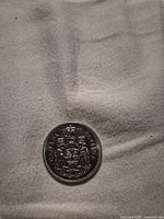 Reverse side of 1970 Canadian 50-cent coin showing Coat of Arms