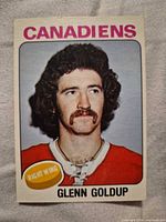 Front of Glenn Goldup O-Pee-Chee card showing player portrait and team header