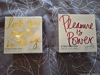 Front view of both sealed card decks showing titles and design