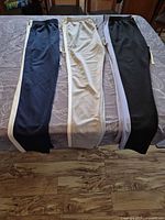 All three jogger pants laid out side-by-side