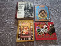 Four hardcover books laid out showing covers