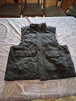 Full front view of black Nike insulated vest