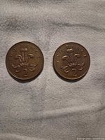 Front view of both coins showing reverse with Prince of Wales feathers and denomination 2