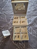 Full view of open Pierre Cardin box showing all jewelry pieces and care card