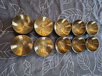 Top view of ten brass bowls arranged in two rows