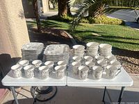 Full set on table showing stacks of plates, bowls, and mugs