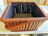 Angled view of basket exterior showing rattan slats and handle