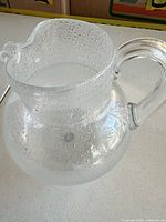 Oblique view showing pitcher shape, bubble pattern and handle