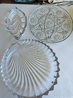 Three clear glass items arranged on surface