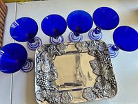 Six cobalt blue stemware and silver-plated tray displayed together
