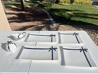 All six Cynthia Rowley ceramic pieces displayed: three square plates, one rectangular plate, lidded sugar bowl, creamer