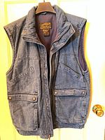Front view of Eddie Bauer blue goose down vest on hanger