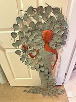 Full view of metal wall sculpture leaning against door