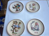Front view of four plates dated 1973, 1974, 1977, 1978
