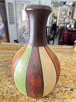 Front view of paneled ceramic vase showing color pattern and shape