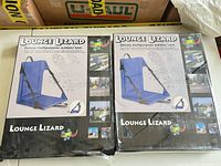 Two sealed Lounge Lizard outdoor seat boxes showing product image and branding