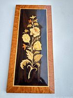 Front view of floral wood marquetry plaque showing entire design and border