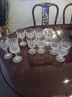 Assorted cut crystal stemware arranged on wooden table