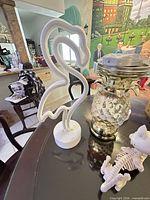 Wide view of flamingo neon lamp, pineapple lamp, cat skeleton on tabletop