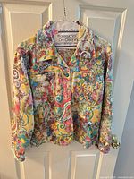Front view of multicolored paisley cotton jacket on hanger
