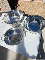 Three stainless steel colanders different sizes