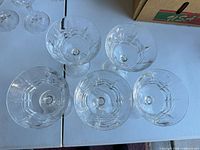 Top view of five cut glass coupe glasses showing pattern and quantity