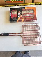 Boxed grill basket set with one handled basket visible