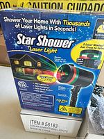 Retail box of Star Shower Laser Light on top of white box marked Item #56183