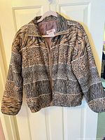 Front view of mixed animal print silk jacket on hanger