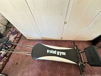 Full view of Total Gym unit showing bench and rails