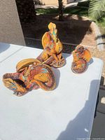 Three dragon figurines on table outdoors