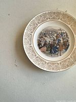 Front view of plate showing gold border and winter scene