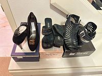 All three pairs of black women’s heels size 8 displayed on boxes