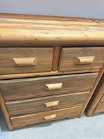 Front view of first dresser showing drawers and wooden pulls