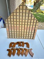 Front view of wooden horse-racing board and game pieces