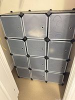 Front view of assembled 12-cube modular storage unit showing panels, connectors, pattern