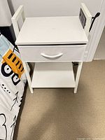 Front view of nightstand showing drawer, shelf, overall design