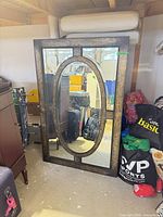 Front view of full mirror showing antique gold distressed frame and oval panel