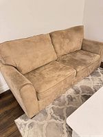 Front view of beige microfiber sofa