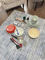 All items laid out showing dinnerware, glassware and utensils