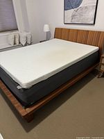 Full view of bed frame with mattress and topper