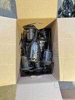 Box containing multiple black solar garden stake lights