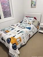 Full view of assembled twin bed showing white upholstered headboard and side rails