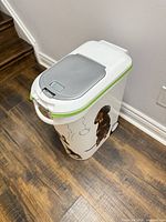 Full view of white plastic pet food bin with wheels and dog graphics