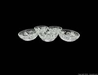 Five of the six clear Prescut bowls, side view showing shape and cut pattern