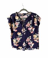 Front view of navy floral blouse on hanger