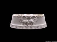 Front view showing cherub relief and pierced border