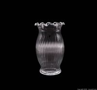 Front view of ribbed clear glass vase showing vertical ribs and ruffled rim